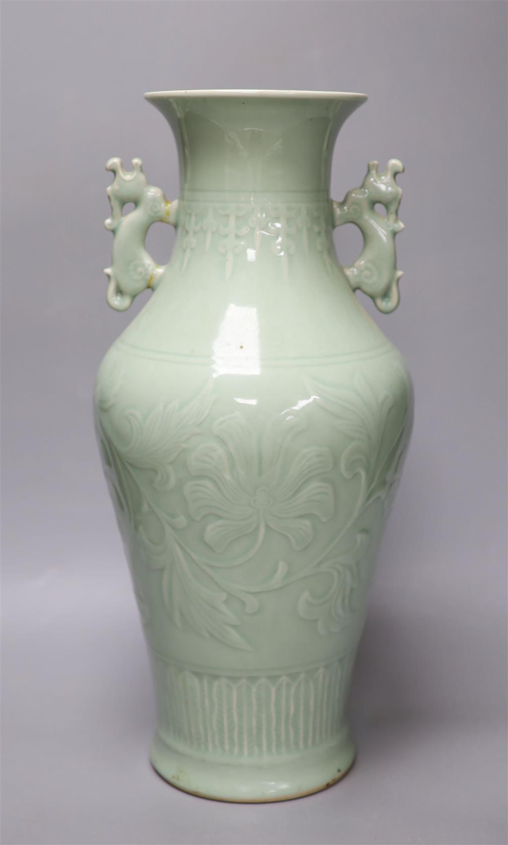 A Chinese green celadon glazed vase, with dragon handles, height 44cm (one re-glued handle)